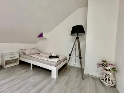 a bedroom with a bed and a lamp and flowers at Aria apartment in Mošnje