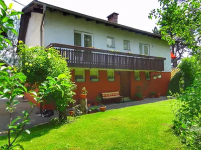 a house with a lawn in front of it at Apartma AS in Lesce