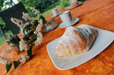 a white plate with a loaf of bread on a table at Apartma AS in Lesce