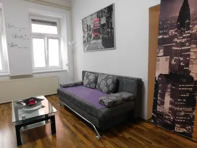 a living room with a couch and a glass table at CityApartment-Maribor in Maribor