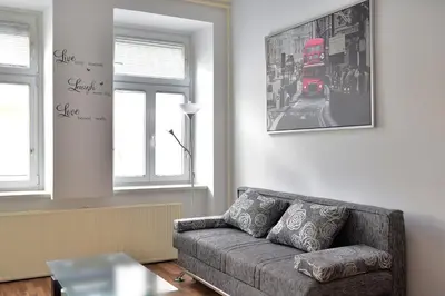 a living room with a couch and a red bus at CityApartment-Maribor in Maribor