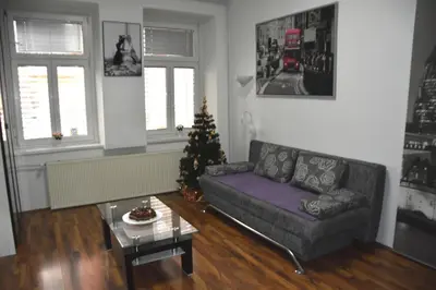 a living room with a couch and a christmas tree at CityApartment-Maribor in Maribor