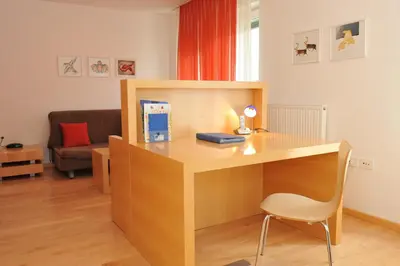 a wooden desk with a chair in a room at Studio Apartment Bor Tour As Ljubljana in Ljubljana