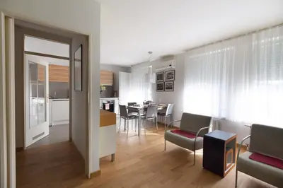a living room and kitchen with a table and chairs at Apartment Eva Tour As Ljubljana in Ljubljana