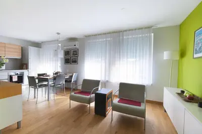 a kitchen and living room with a table and chairs at Apartment Eva Tour As Ljubljana in Ljubljana
