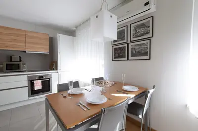a dining room with a wooden table and chairs at Apartment Eva Tour As Ljubljana in Ljubljana