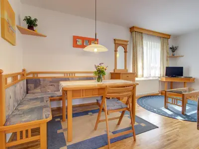 a living room with a table and a couch at Apartments Orazem in Bled