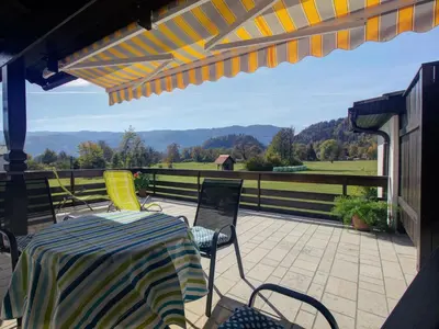 a patio with a table and chairs and a fence at Apartments Orazem in Bled