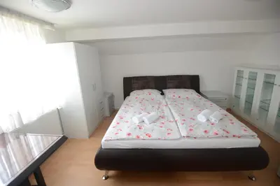 a bedroom with a bed with flowers on it at Family Villa Bled in Bled