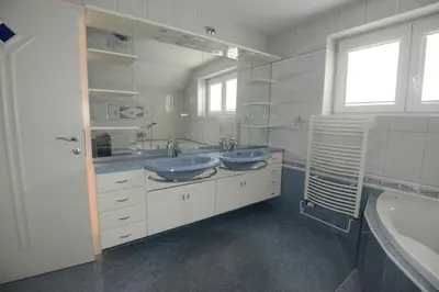 a white bathroom with two sinks and a tub at Family Villa Bled in Bled