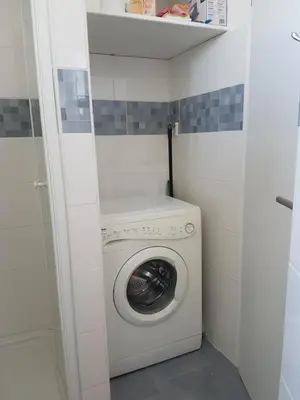 a washer and dryer in a small bathroom at Apartment Gondola in Maribor