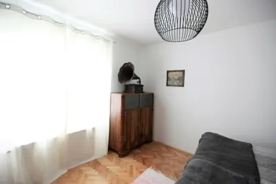 a living room with a couch and a pendant light at Apartment Gondola in Maribor