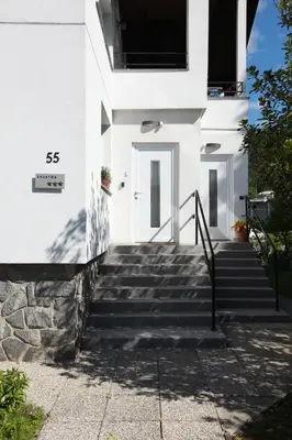 a white house with stairs in front of it at Apartment Gondola in Maribor