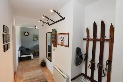 a hallway with snow skis on the wall at Apartment Gondola in Maribor