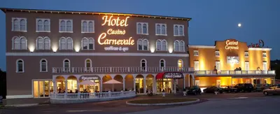 a hotel with neon signs on the side of a building at Casino & Hotel ADMIRAL Skofije in Zgornje Škofije