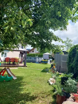 a yard with a playground and a house at Apartma Žirovnik in Cerklje na Gorenjskem