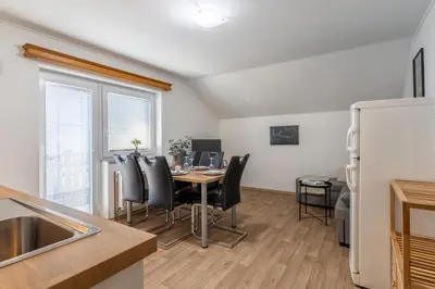 a kitchen and dining room with a table and chairs at Apartments Orel in Mozirje