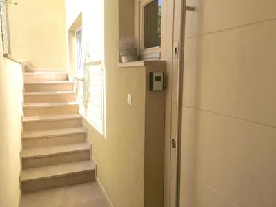 a stairway leading up to a window in a building at Sensei apartment in Ljubljana