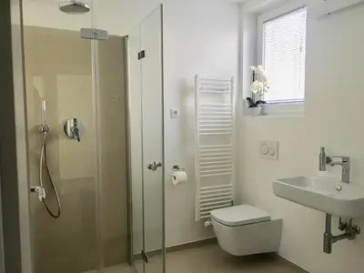 a bathroom with a shower and a toilet and a sink at Sensei apartment in Ljubljana
