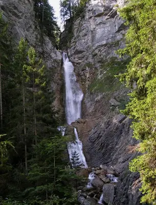 a waterfall on the side of a rocky mountain at PR`Cajhn in Radovljica