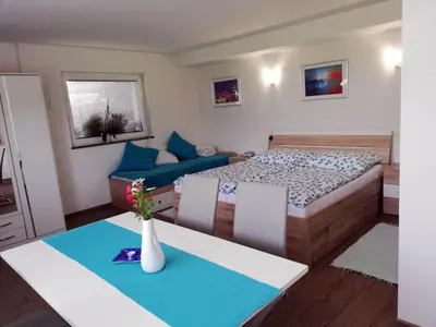 a small bedroom with a bed and a couch at PR`Cajhn in Radovljica