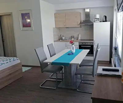 a kitchen with a table and chairs in a room at PR`Cajhn in Radovljica