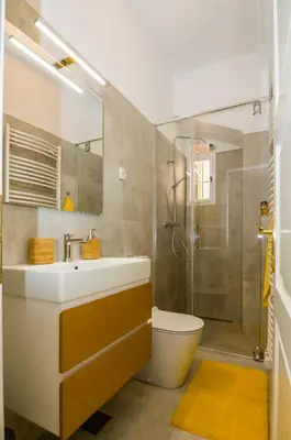 a bathroom with a toilet and a sink and a shower at Elegant Central Apartment in Ljubljana