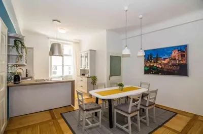 a kitchen and dining room with a table and chairs at Elegant Central Apartment in Ljubljana