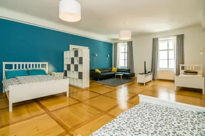 a bedroom with a bed and a blue wall at Elegant Central Apartment in Ljubljana