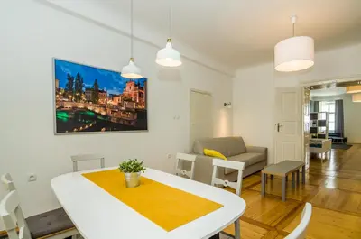 a living room with a table and a couch at Elegant Central Apartment in Ljubljana