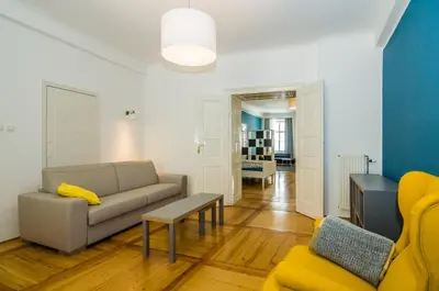 a living room with a couch and a table at Elegant Central Apartment in Ljubljana