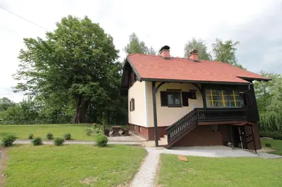 a small house with a red roof in a field at Holiday Home Winzerhaus Eva in Špičnik