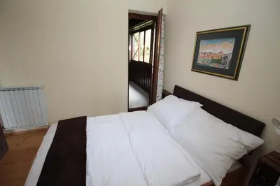 a white bed in a room with a mirror at Holiday Home Winzerhaus Eva in Špičnik