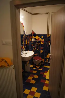 a bathroom with a sink and a colorful floor at Domas RD Apartment in Ljubljana