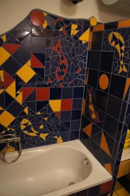 a bathroom with a bath tub with a mosaic tile wall at Domas RD Apartment in Ljubljana