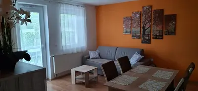 a living room with a table and a couch at Alpes in Radovljica