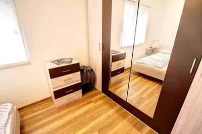 a mirror in a room with a bed and a bedroom at Apartment Vita near Terme Paradiso in Dobova