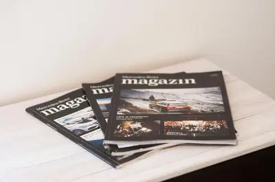 two magazines sitting on top of a table at Apartment Vita near Terme Paradiso in Dobova