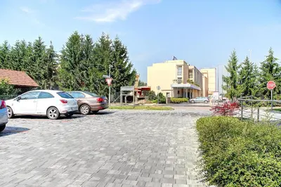 two cars parked in a parking lot with a stop sign at Apartment Vita near Terme Paradiso in Dobova