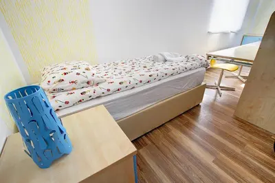 a small bedroom with a bed and a table at Apartment Vita near Terme Paradiso in Dobova