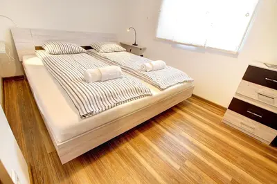 a bed with two pillows on it in a bedroom at Apartment Vita near Terme Paradiso in Dobova