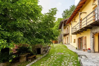 an alley in a house with trees and grass at Posestvo Laz - The Laz Estate in Voglarji