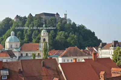 a group of buildings with a mountain in the background at i Design Apartment in Ljubljana