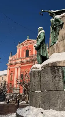 a statue of a woman in front of a building at i Design Apartment in Ljubljana