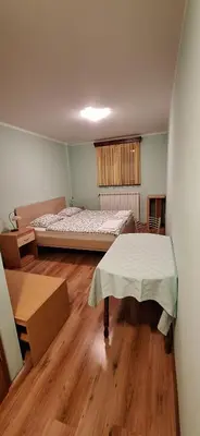 a room with a bed and a table in it at Farm stay File in Slope