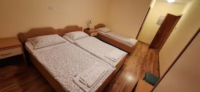 two beds in a small room with a mirror at Farm stay File in Slope
