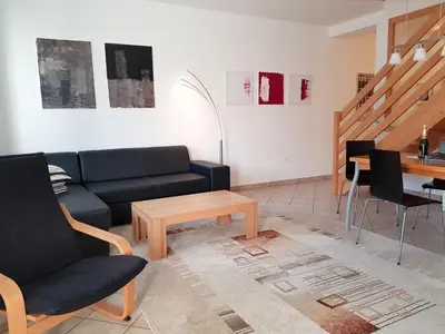 a living room with a couch and a table at Apartment Montis Bovec in Bovec