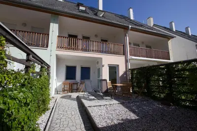 a patio of a house with chairs and a table at Apartment Montis Bovec in Bovec
