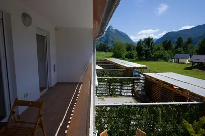 a balcony of a building with a view of mountains at Apartment Montis Bovec in Bovec