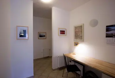 a room with a desk with a lamp on it at Apartment Montis Bovec in Bovec